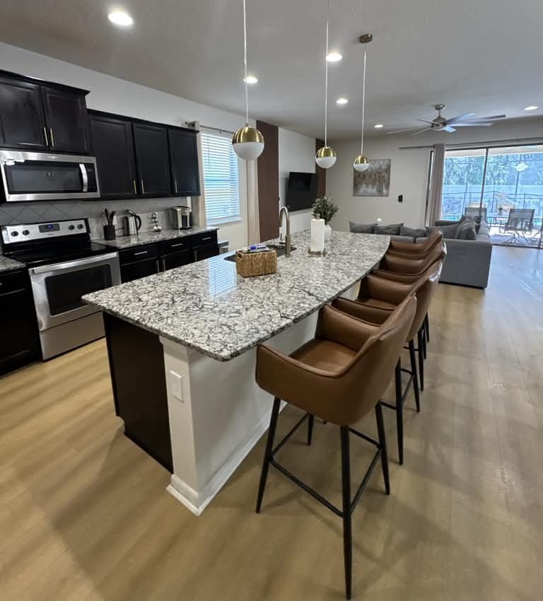 Kitchen island with granite top and bar stools